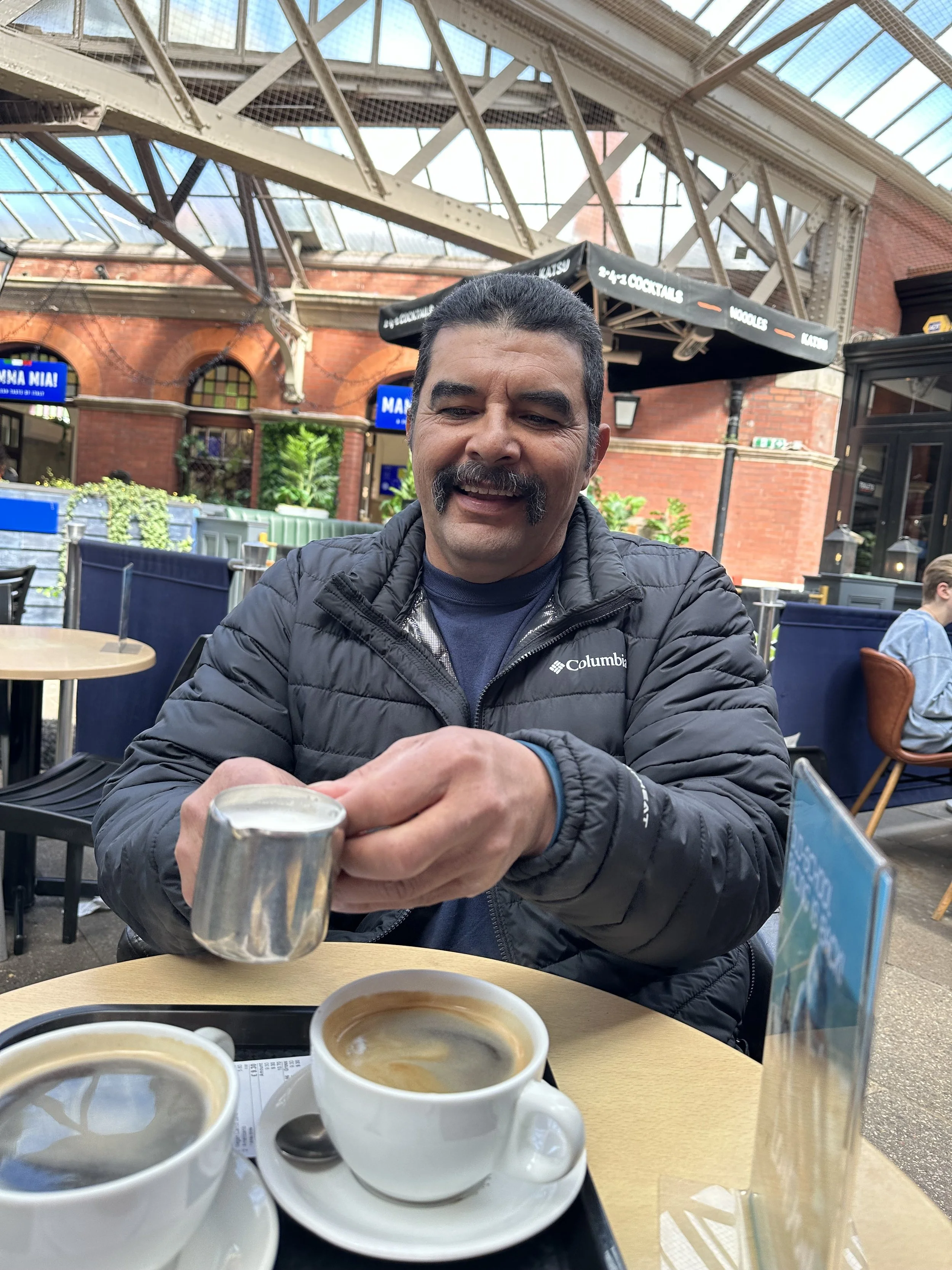 Marisol Hernandez, "Mmm, Coffee," 2024. This is a photo of my father in London, at an outdoor cafe. During our trip to the British Isles during spring break, my father and I bonded over coffee everywhere we went. When it wasn't coffee, it was gelato.
