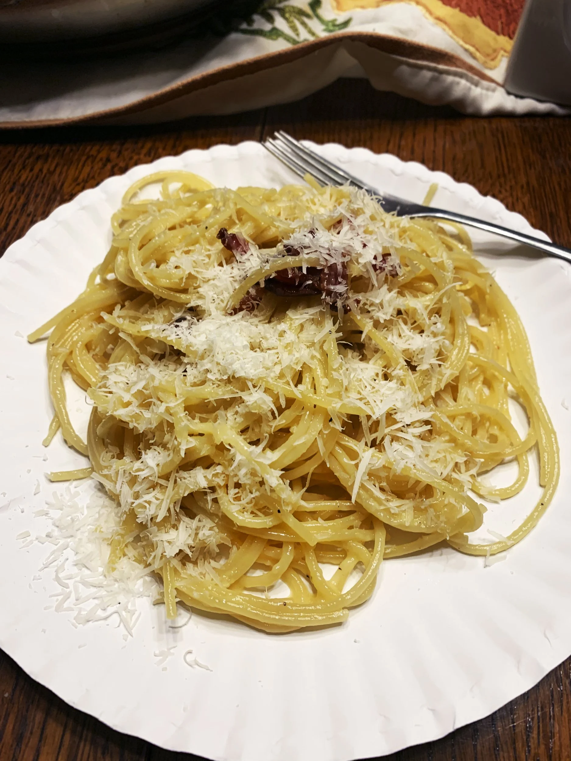 Leif Russon, "A Poor Man's Meal," 2022.
Spaghetti carbonara: eggs, cheese, and a touch of pre-cooked bacon served on a paper plate. Because my mother is out of town, I cook for my siblings. We eat cheap with as few dishes to wash as possible.
