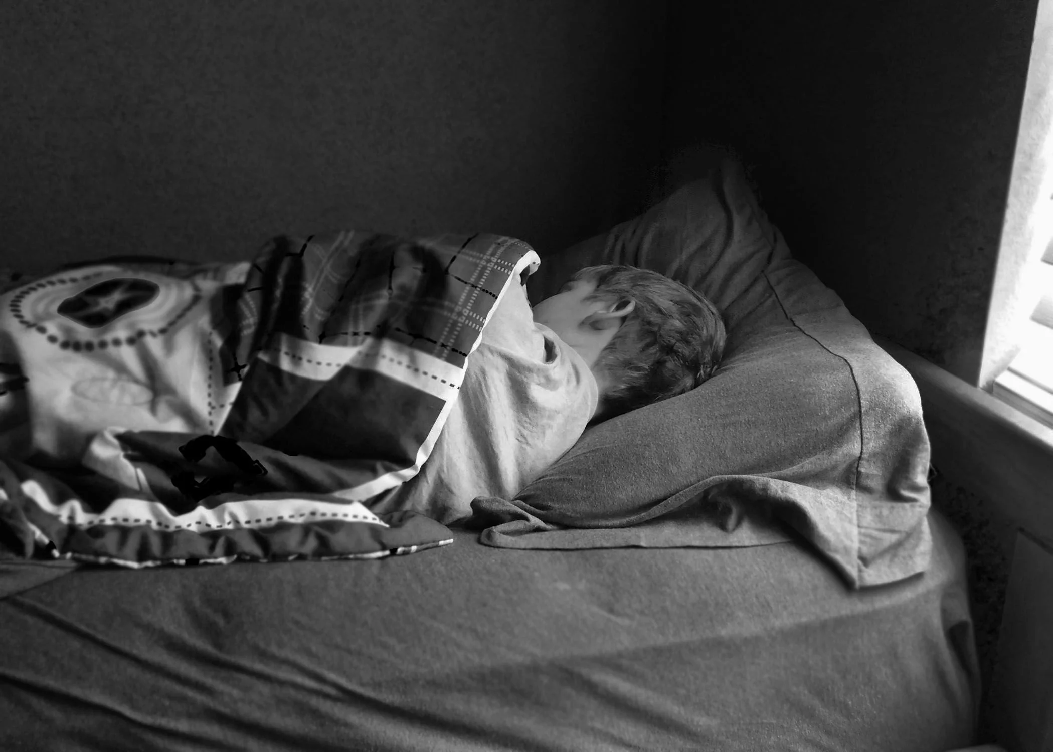 Jade Fisher, "The Cool Side of the Pillow," 2020. "My brother, Landyn, is 11 and has a hard time waking up in the morning for school. He groans and rolls to his other side, pulling the blankets closer to his head as the cold breeze rolls in through h