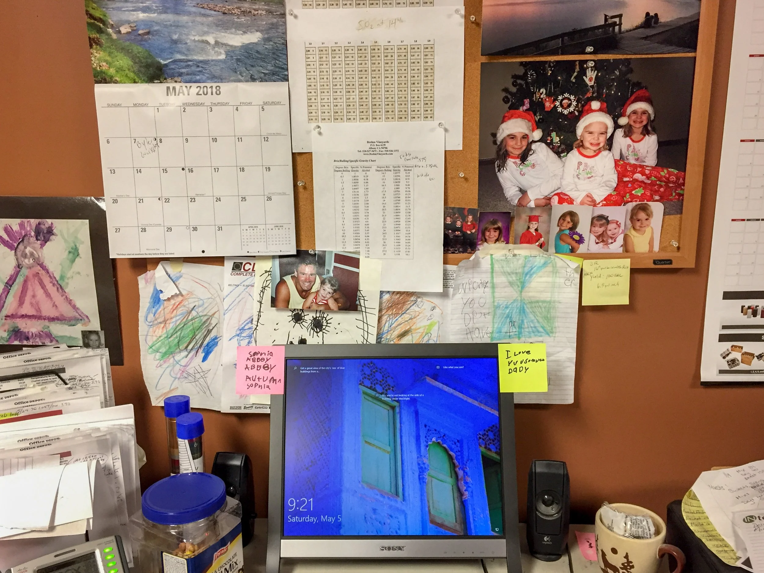 Abbey Geeting, "Untitled," 2018. "This picture of my dad's desk shows a small part only of his big office at the winery. This is where he keeps calendars, various tables, lots of paperwork, and photos of my two younger sisters and me, and, old artwor