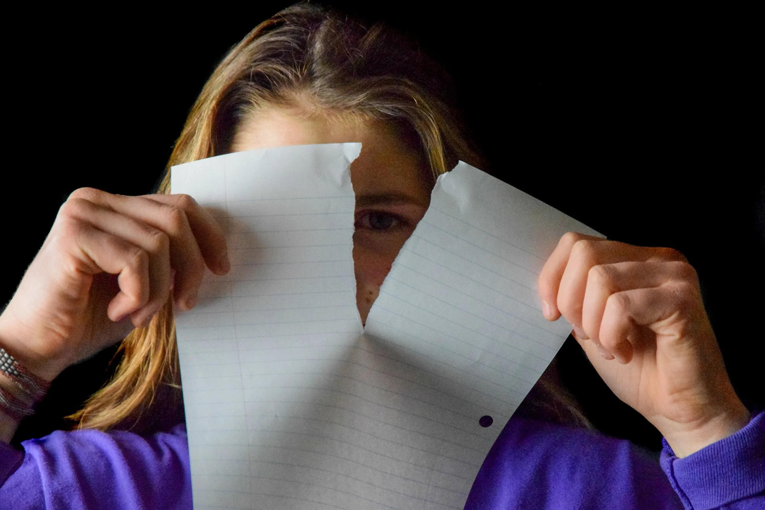 Cleo Anderson, "Untitled," 2018. "My sister, a high school freshman, is already confronted with stress as a result of academic pressure and because of the social climate of her time. Her peering through a tear in a paper is a metaphor for observing t