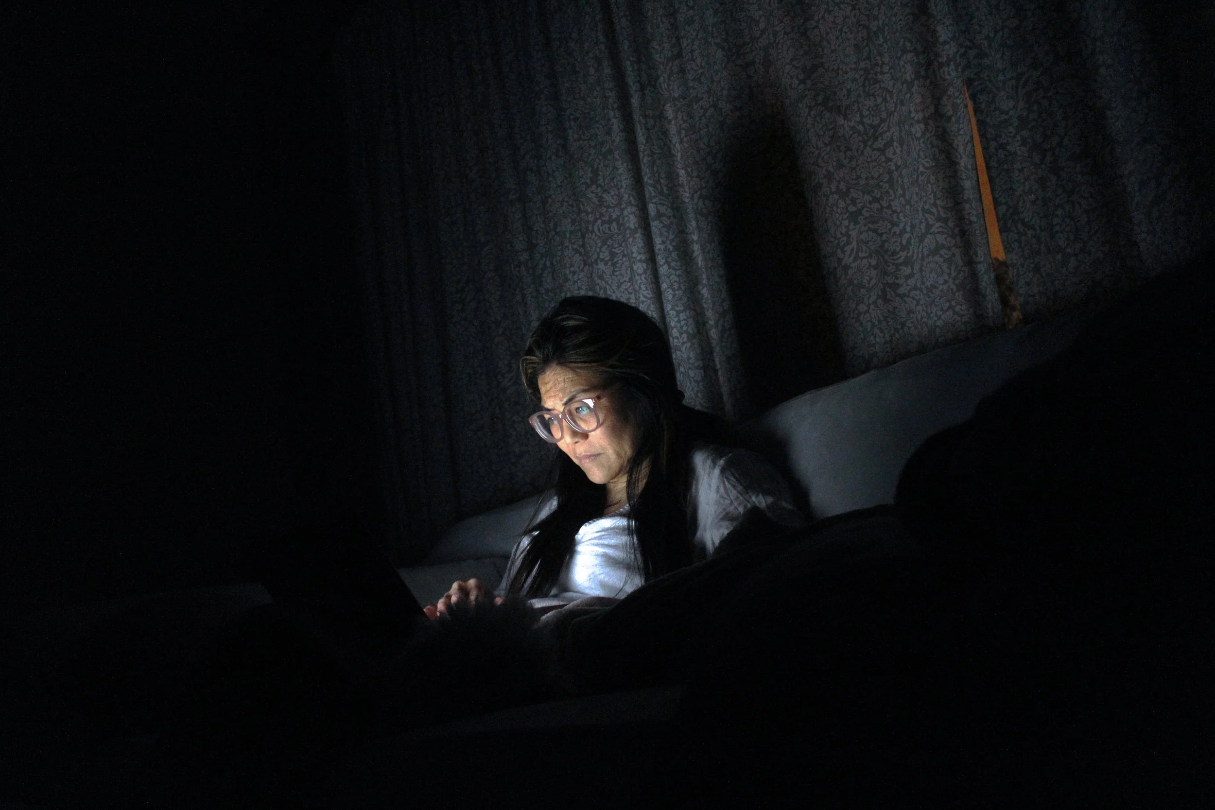 Mikaylie Kiyomura, "Computer Light," 2020. "After the whole family has already gone to bed, my mom stays up to finish work and other tasks. Whenever I see her, she is sitting in the dark with nothing but her computer screen lighting up the room. My m