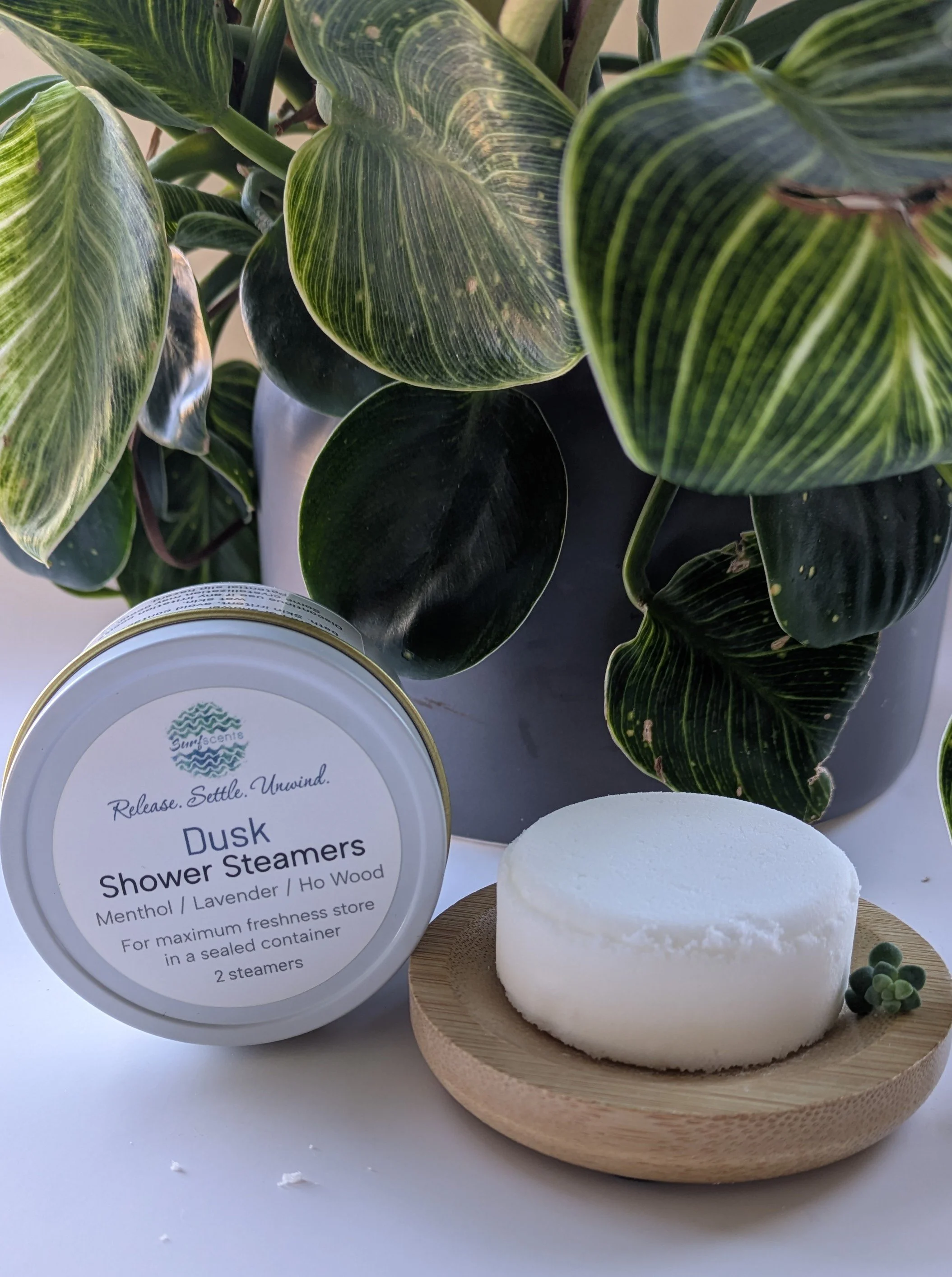 Dusk Shower Steamers in minimalist tin and refill cylinder — calming lavender and ho wood blend for an evening shower ritual.