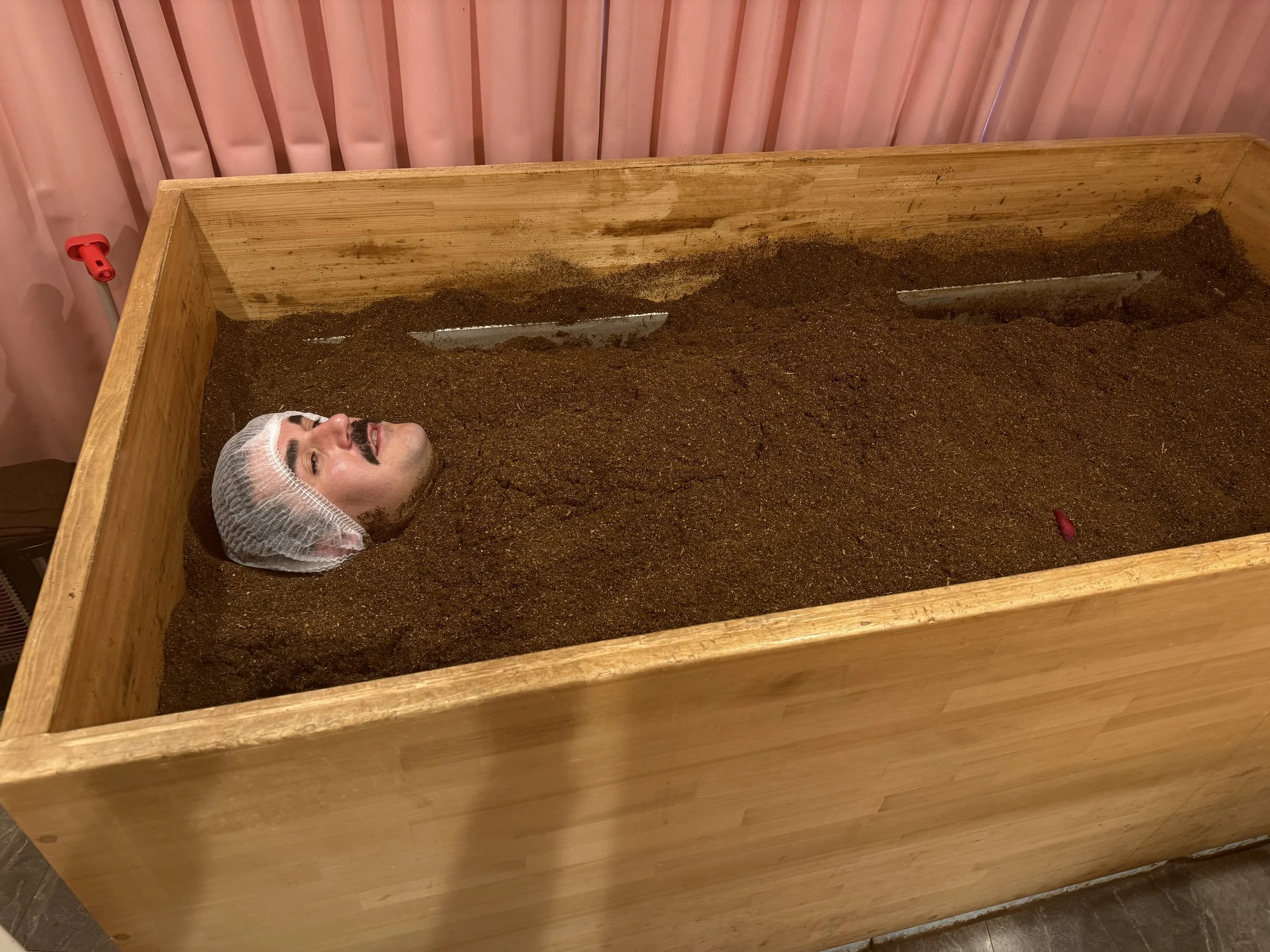 Man in Cedar Rice Bran Enzyme Bath Japan