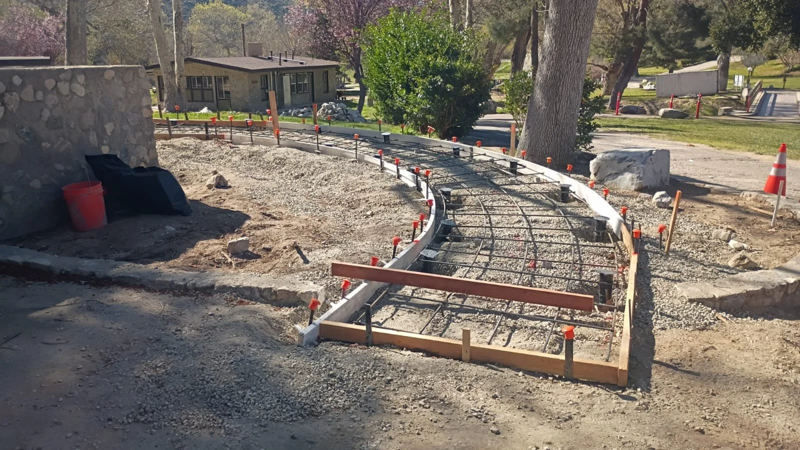 Curved walkway formwork and reinforcing steel before concrete placement.