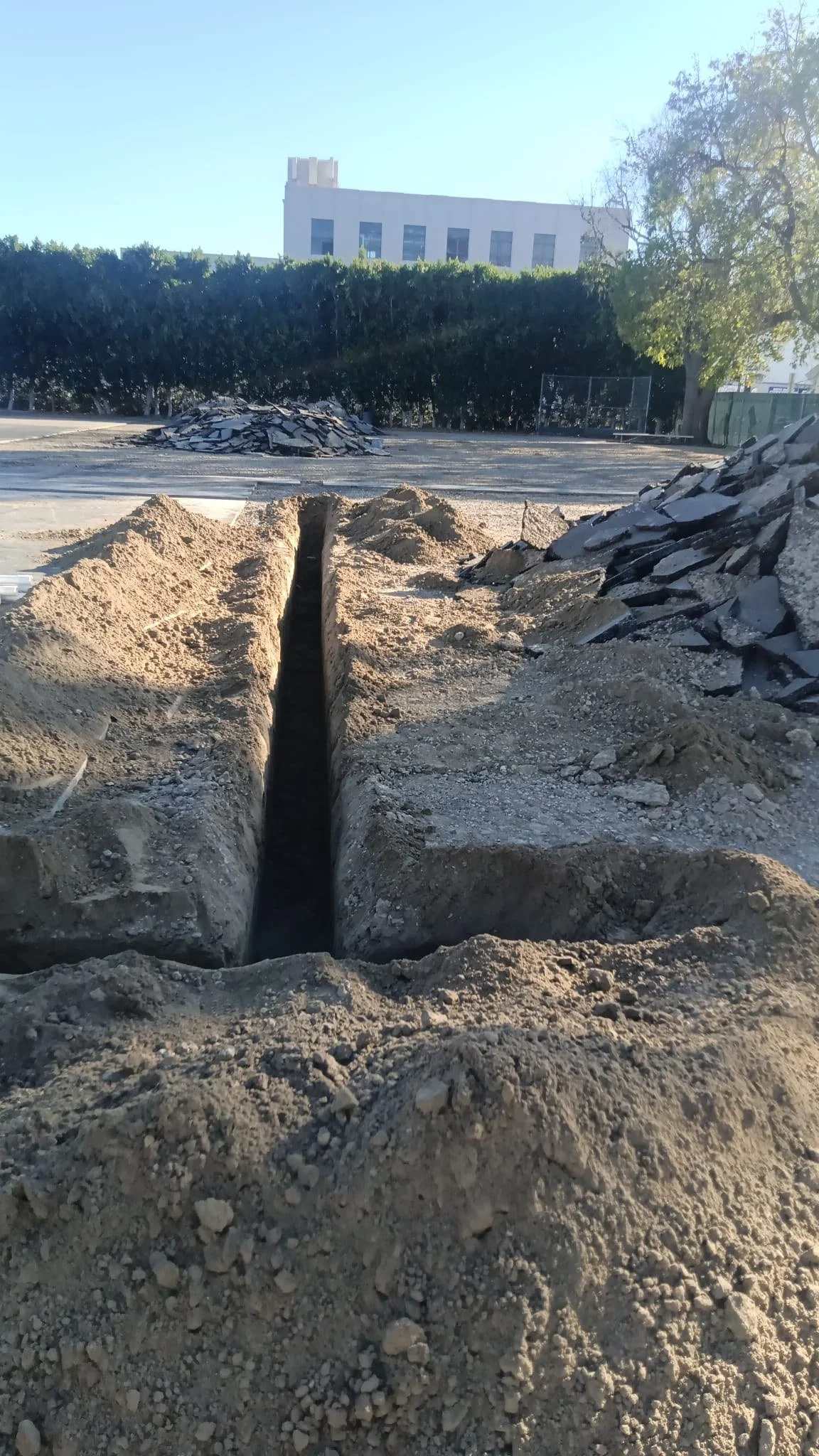 Excavation and trenching during schoolyard construction.