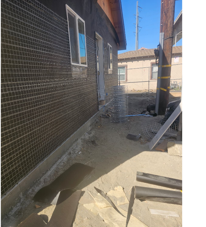 Exterior wall with weather barrier and metal lath before stucco