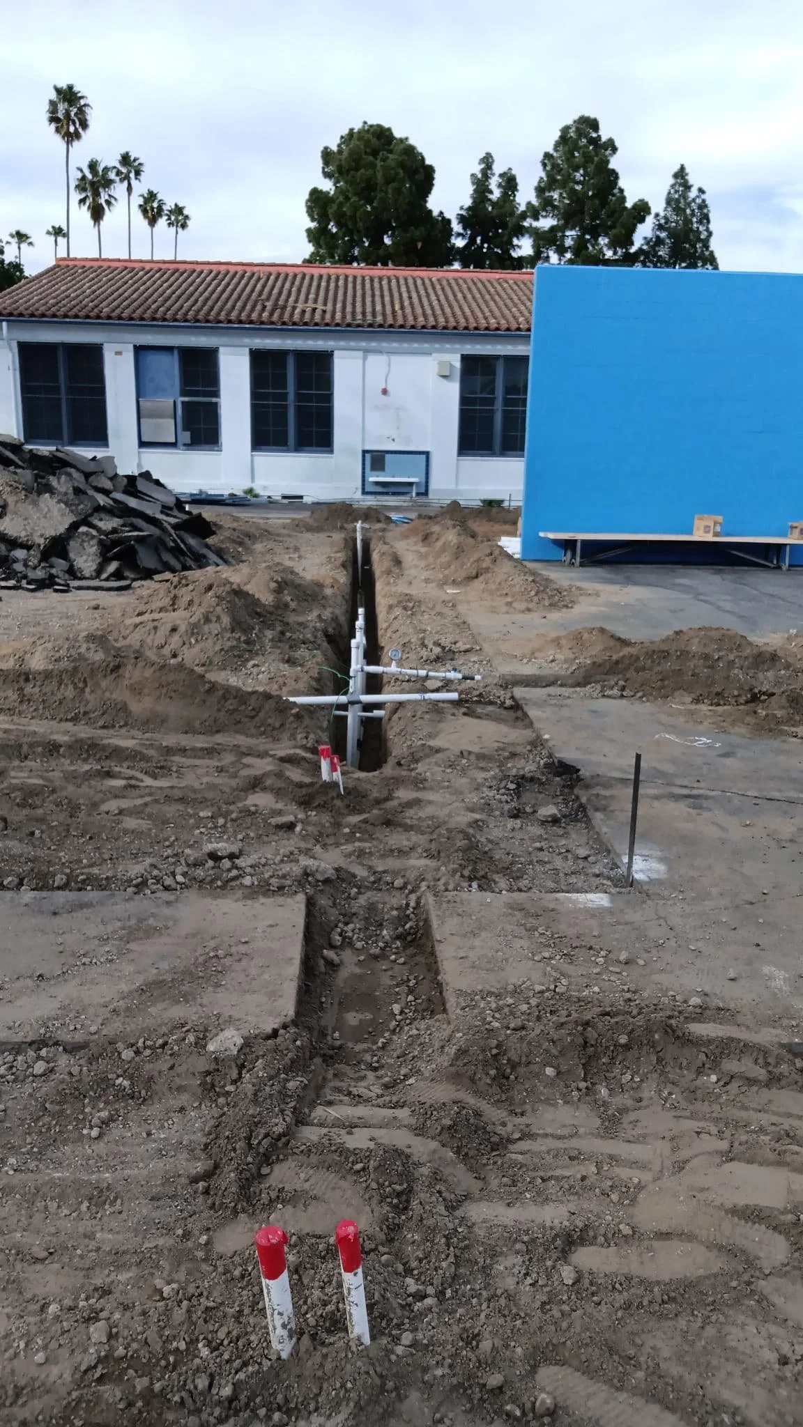 Underground piping installed in excavated trenches.