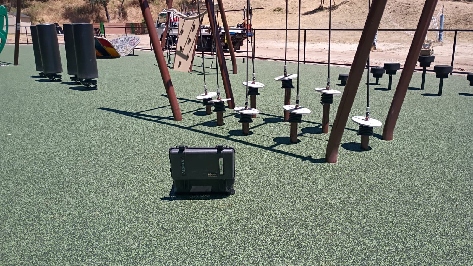 Suspended stepping platforms and surrounding obstacle course equipment.