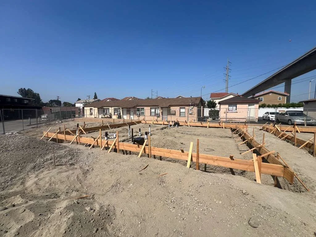 Foundation formwork and plumbing pipes before concrete placement