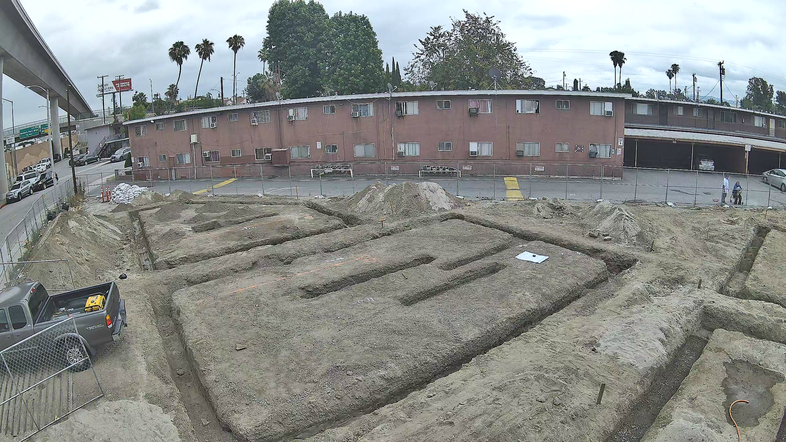 Foundation footing trenches across the multifamily construction site