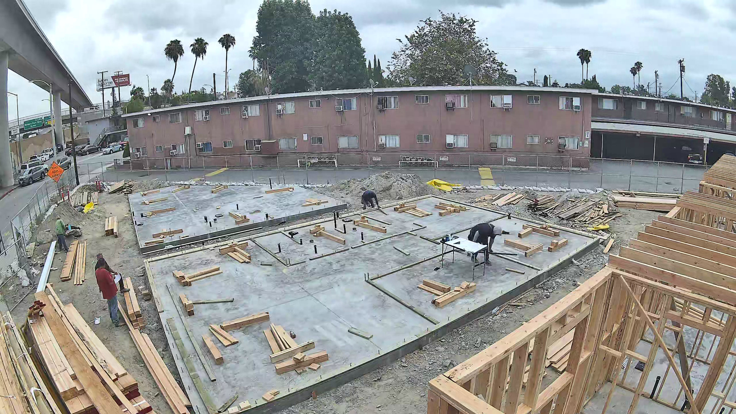Concrete foundation slabs with lumber layout and framing in progress