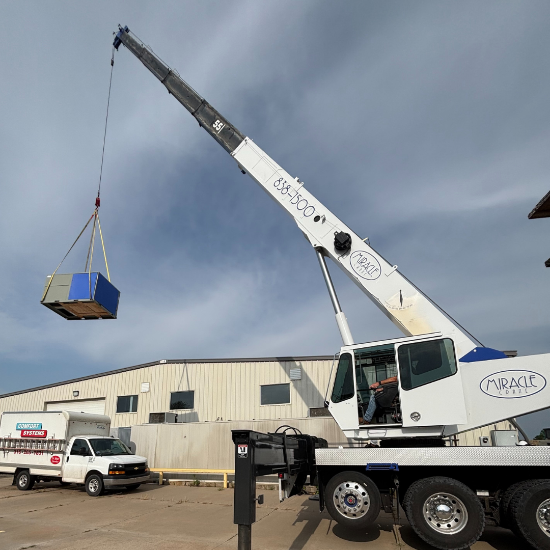 Miracle Crane's mobile crane lifting a roof top unit for a Wichita HVAC company.