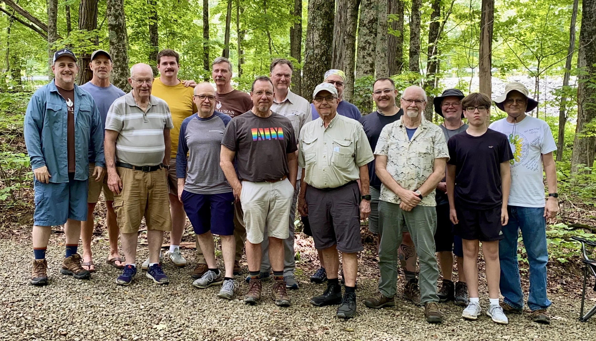 Men of Ohio Illuman gathered on a wooded trail at the 2025 Wandering