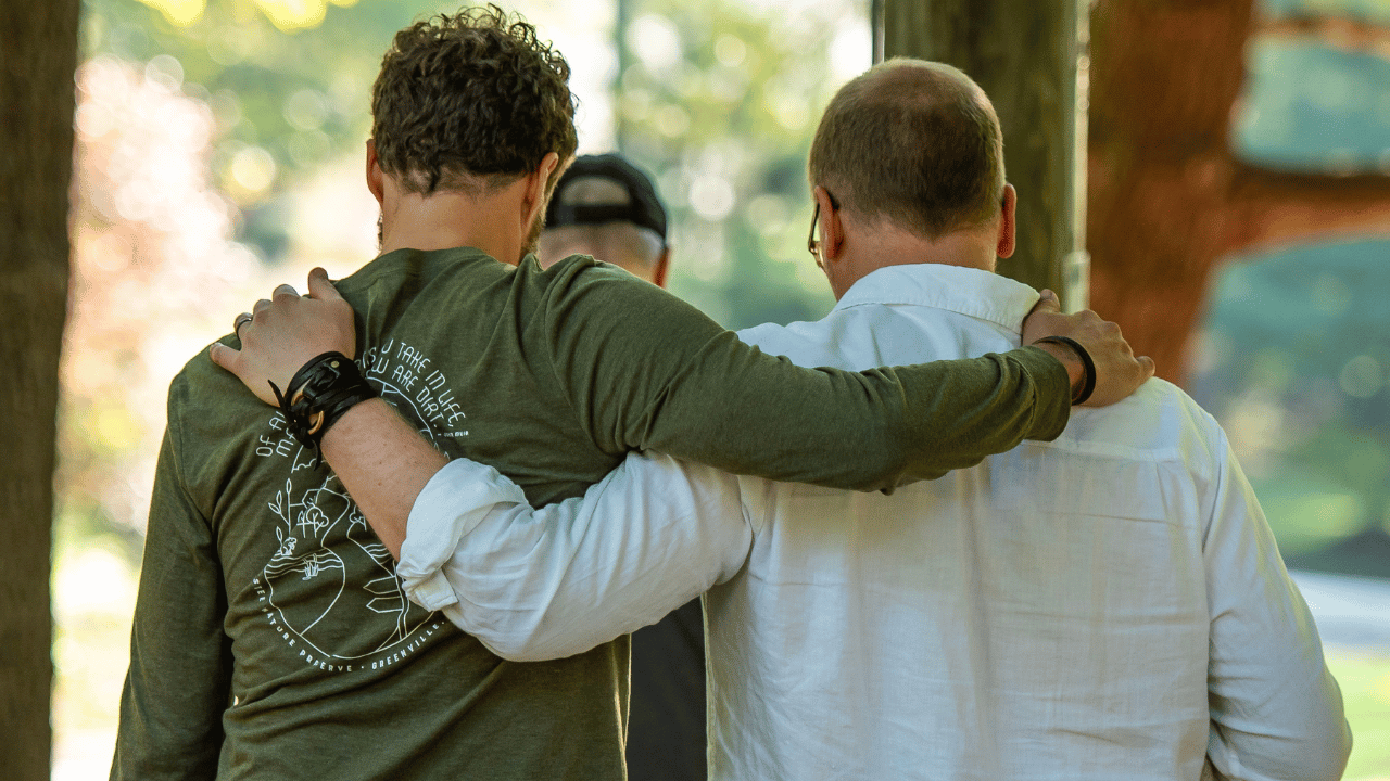 Illuman men arm in arm at an EROP