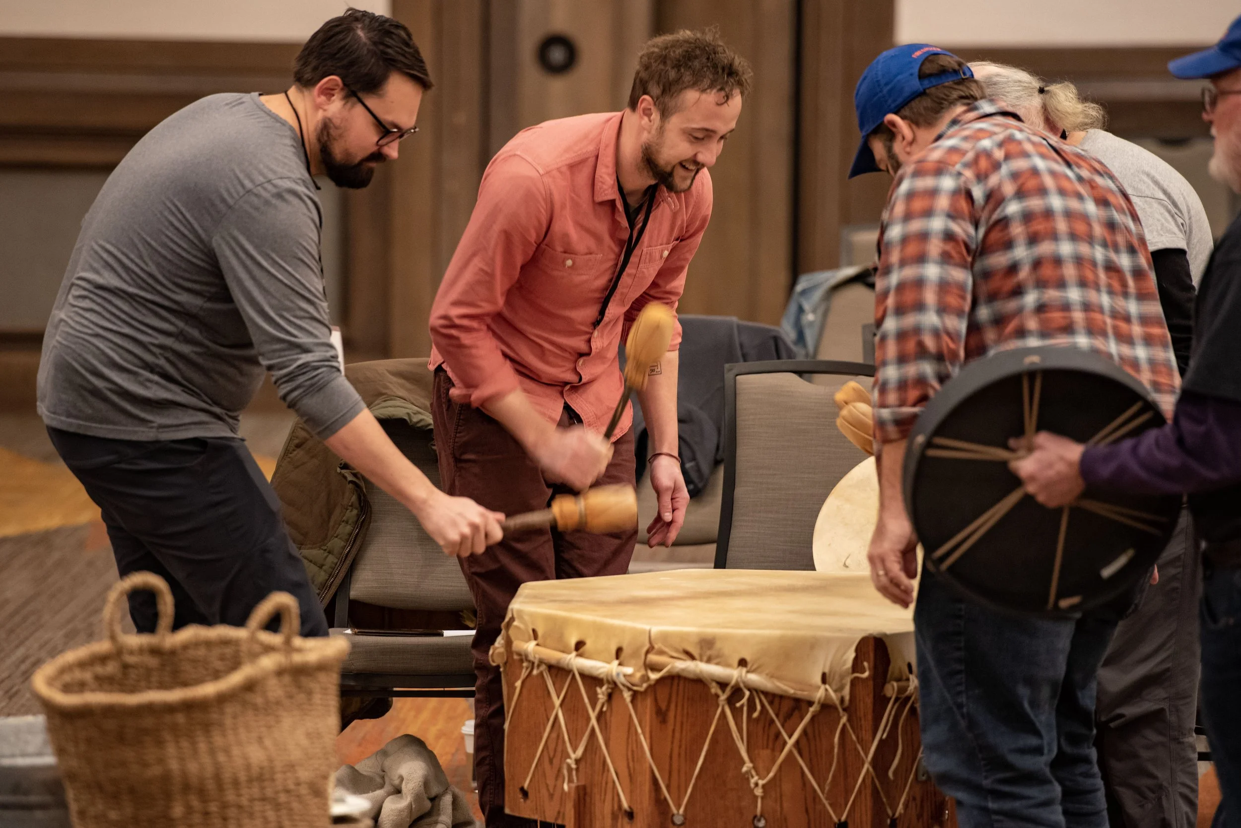 Illuman Men Bonding together over Drumming at an Awaken Event