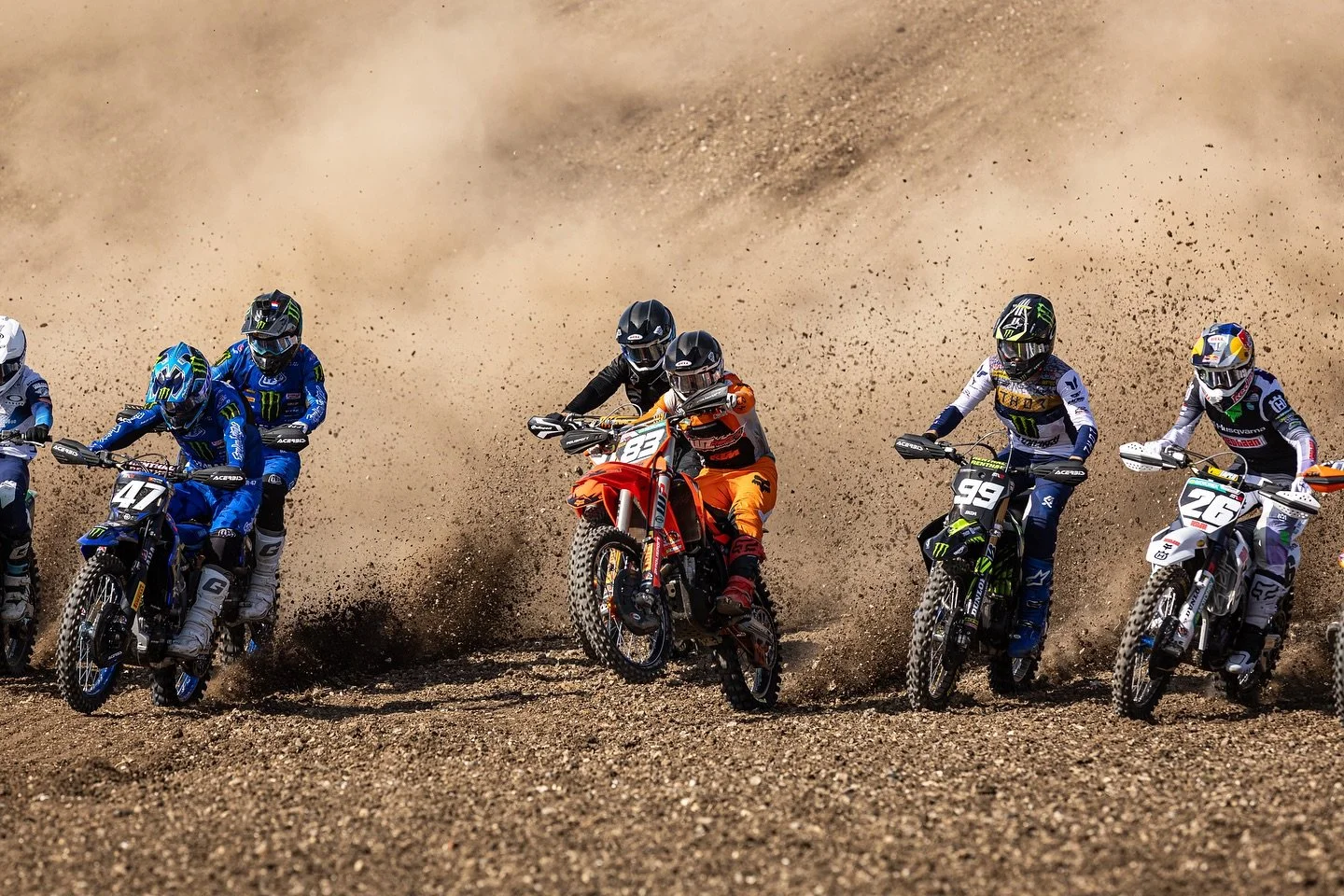 motocross riders racing in dusty conditions