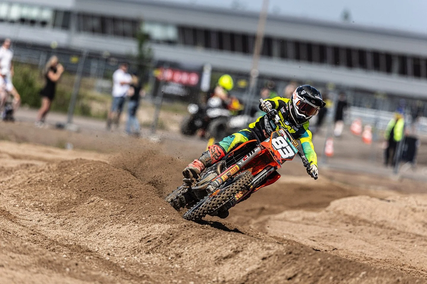 motocross rider cornering on sandy track