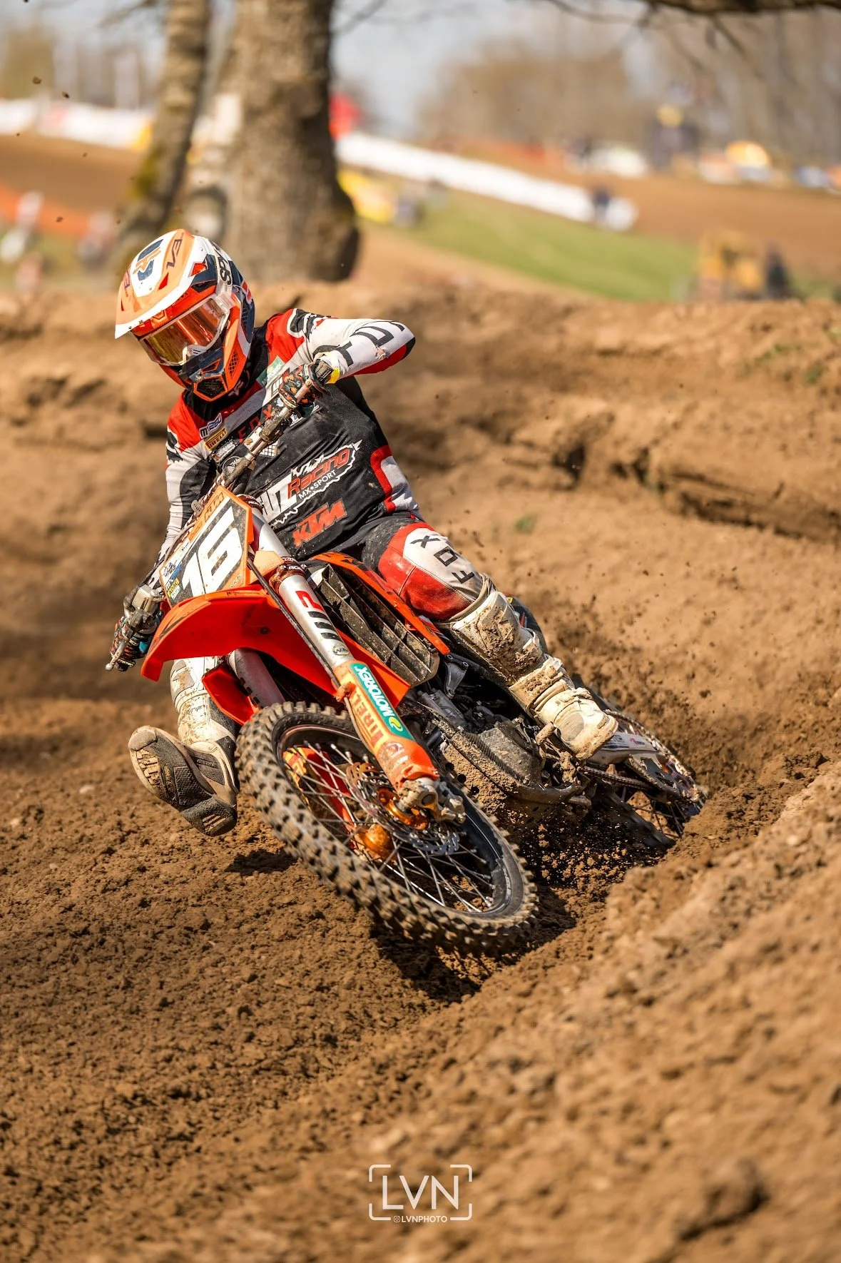 motocross rider cornering in sandy track section