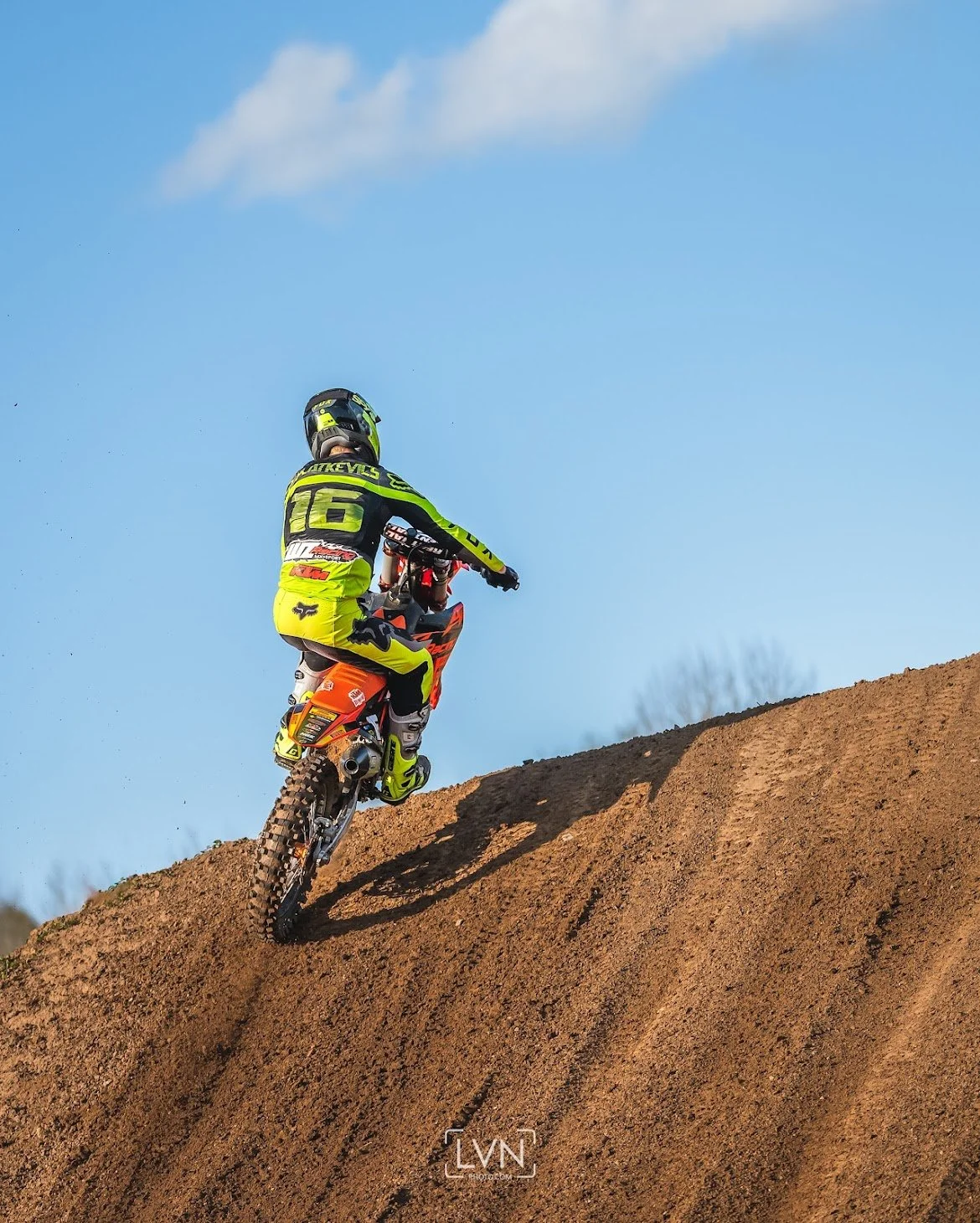 Motocross rider on a KTM taking off for a jump and doing scrub