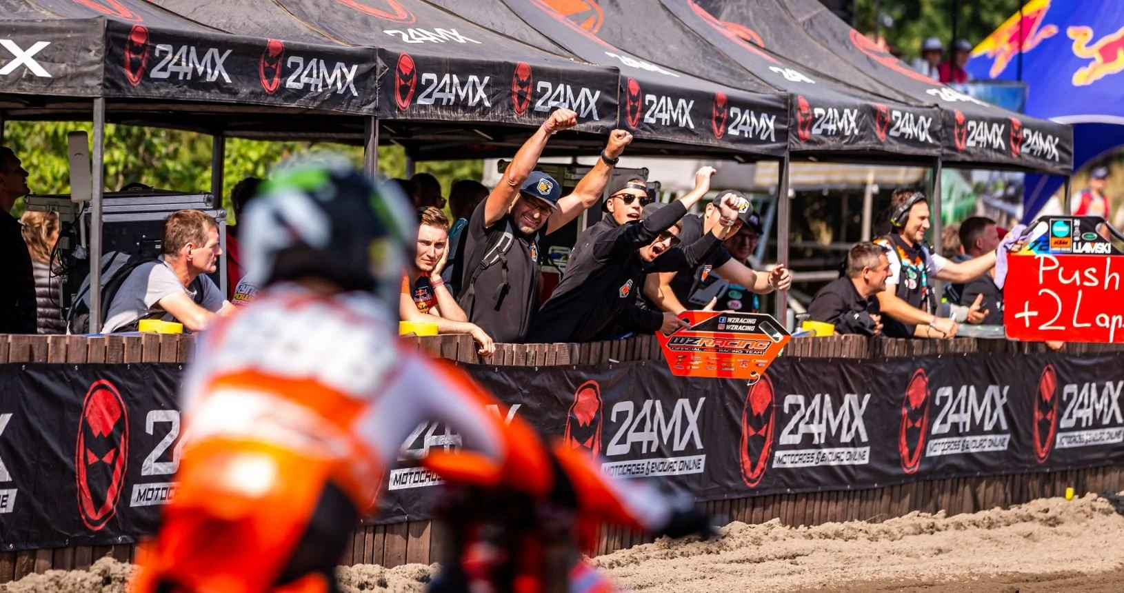 WZ Racing KTM mechanics cheering rider from mechanics zone