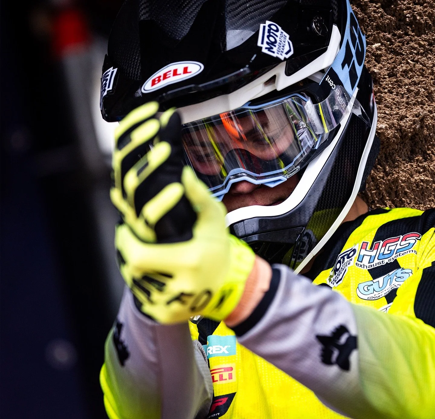 motocross rider adjusting gear before race