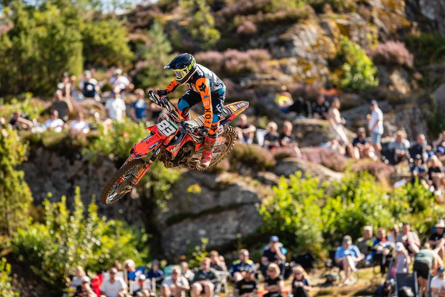 motocross rider jumping with crowd in background