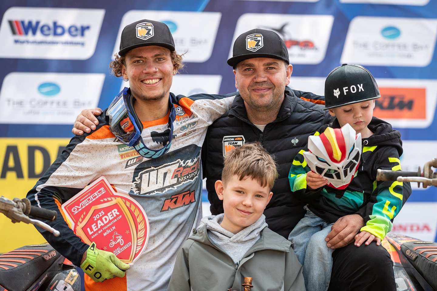 motocross rider podium moment with family