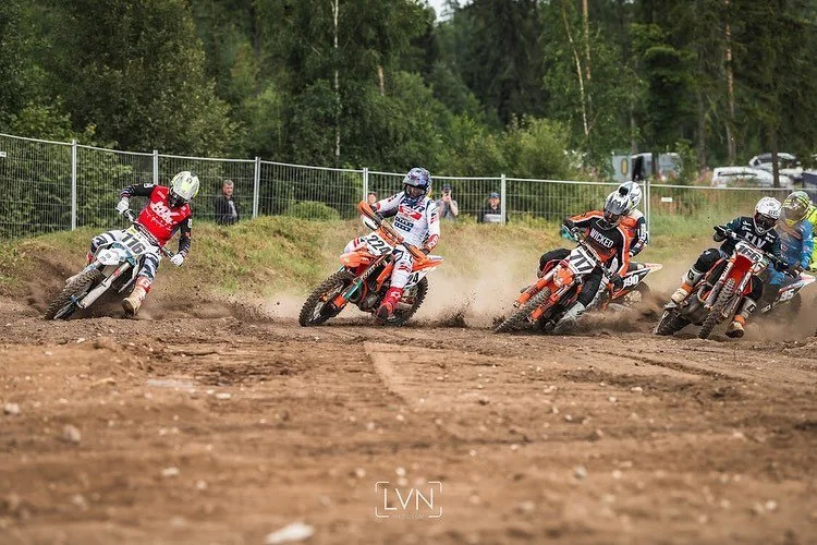 motocross race start with multiple riders on dirt track first corner