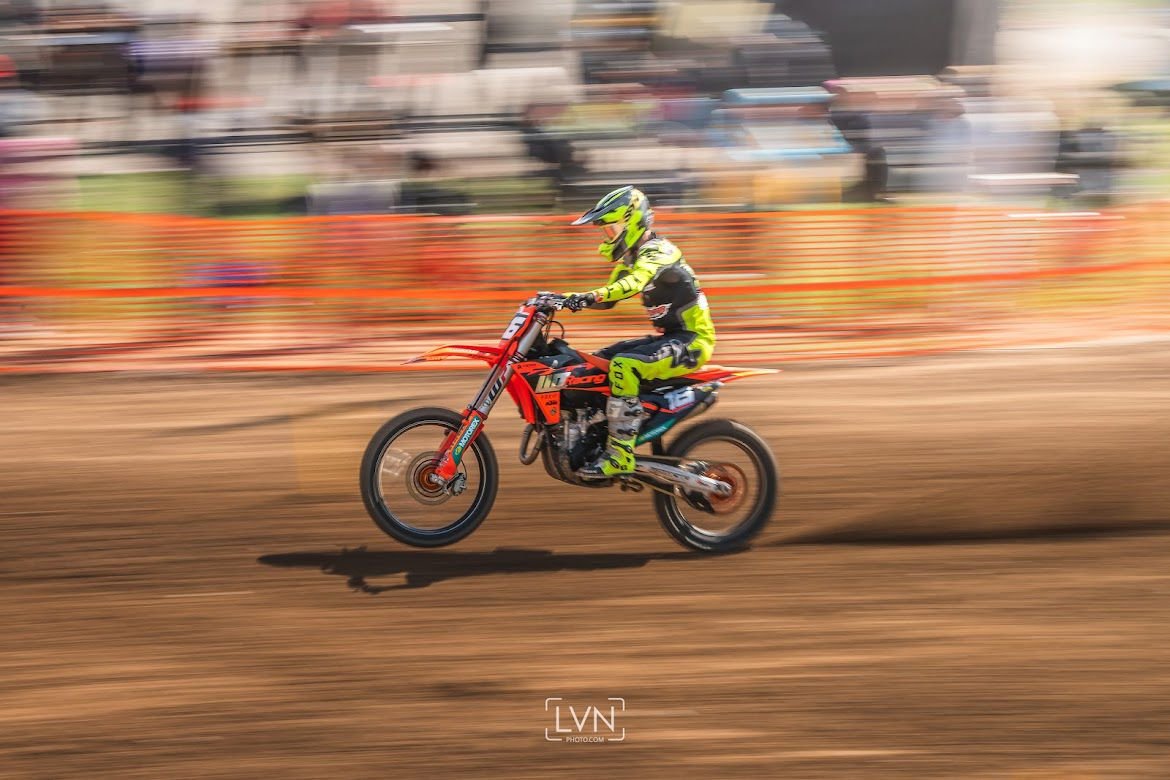 motocross rider riding fast on dirt track