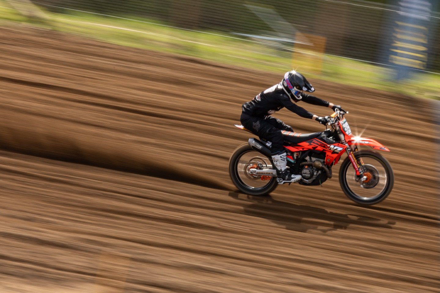 motocross rider riding on dirt track top view