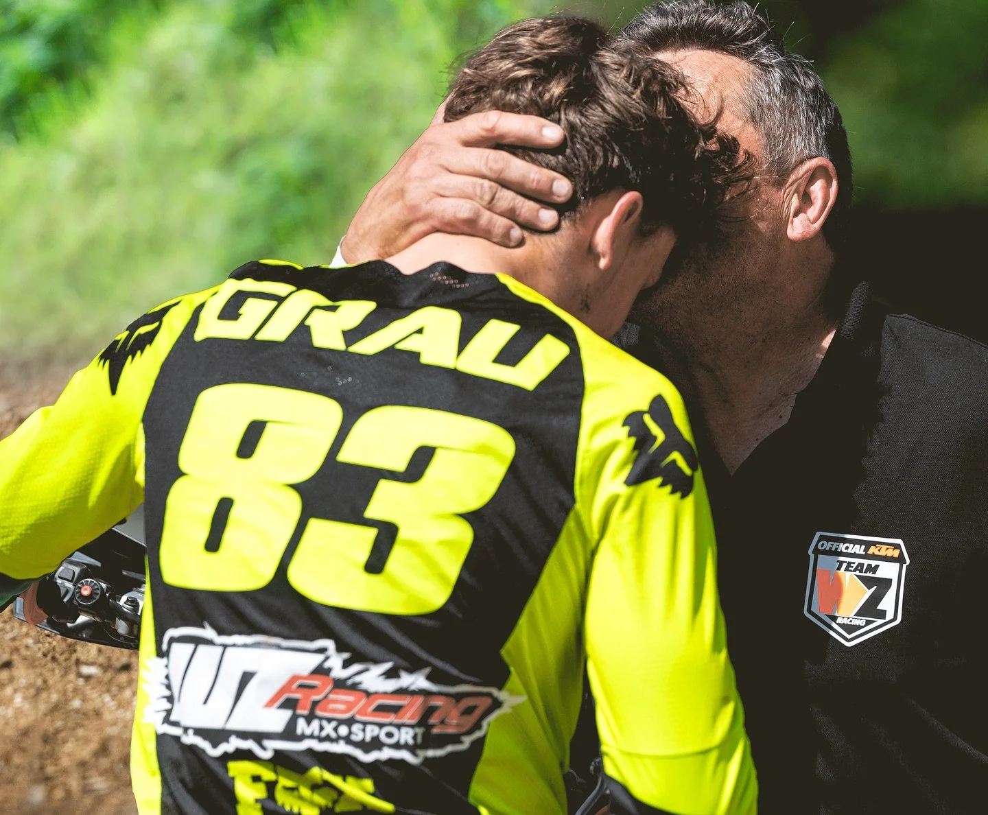 motocross rider team support moment