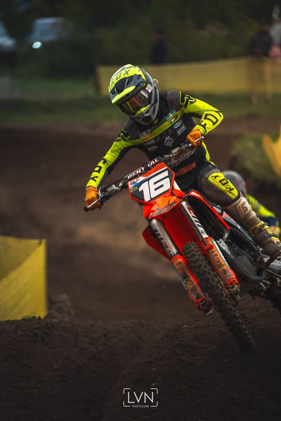 KTM motocross rider cornering on dirt track