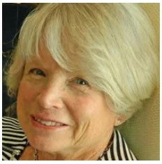 Close-up of an older woman with short, light-colored hair smiling.