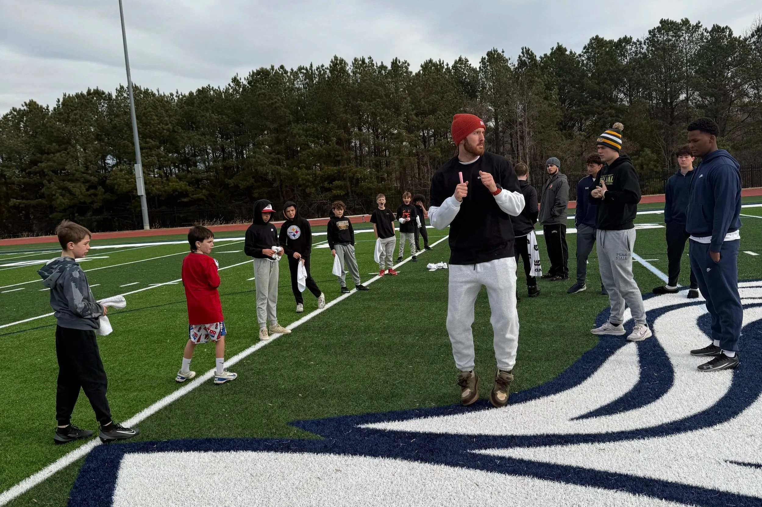 Middle school quarterbacks training on field in southern maryland
