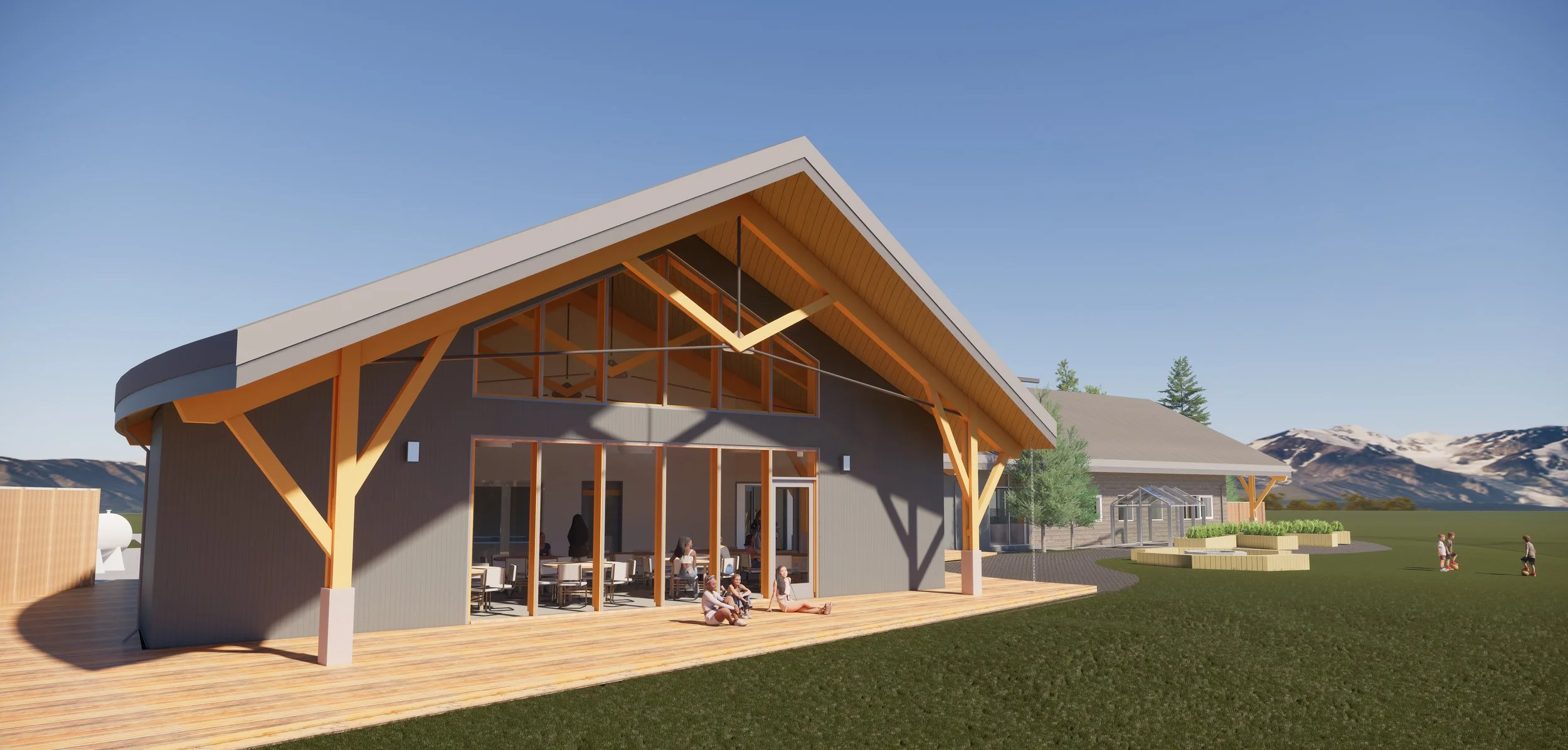 Render of a modern building with large windows, wooden accents, and an outdoor patio, set in a scenic landscape with green grass, trees, and mountains in the background, and children playing outside.