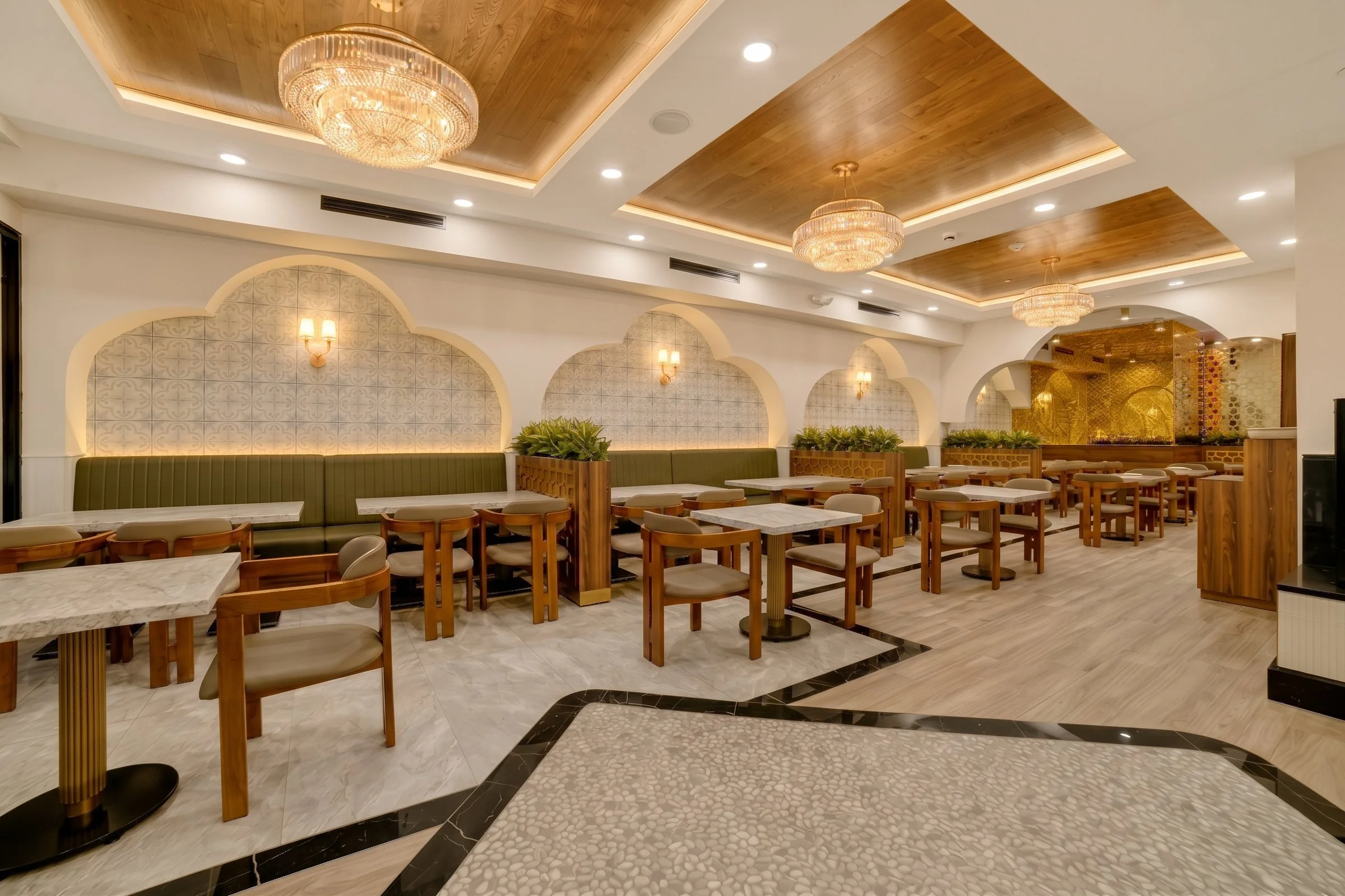 aSocotra Restaurant main dining room in Clifton NJ with wood coffered ceilings, crystal chandeliers and scalloped arch banquettes