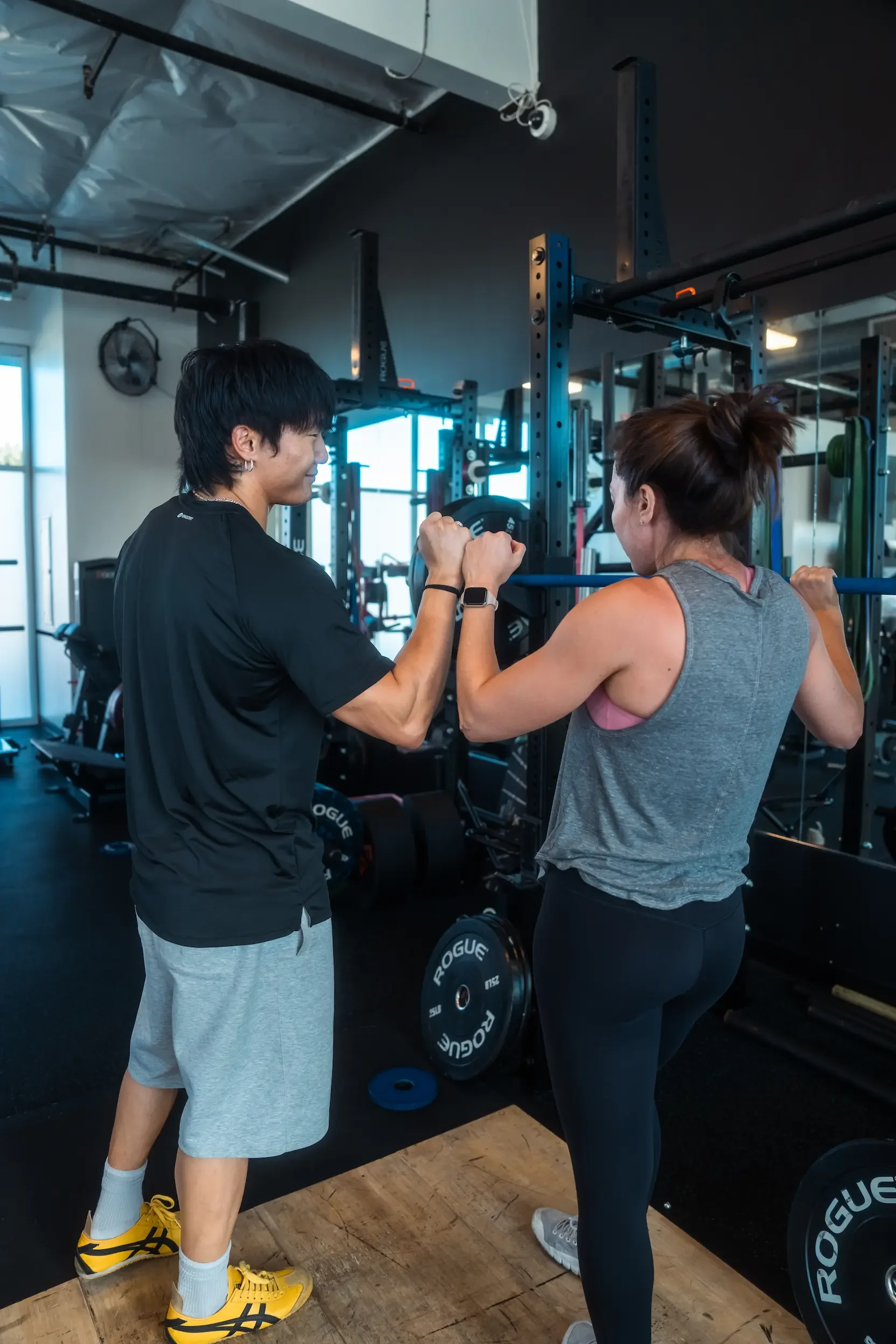 Members high-fiving after a group strength workout at Next Level Fitness