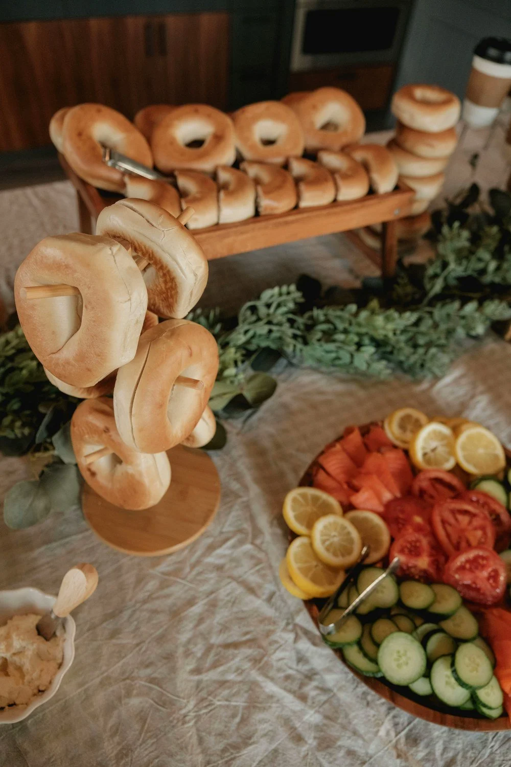 A spread of bagels and toppings on a table, like the monthly coffee-and-bagels gathering that welcomes new neighbors in Mission Beach