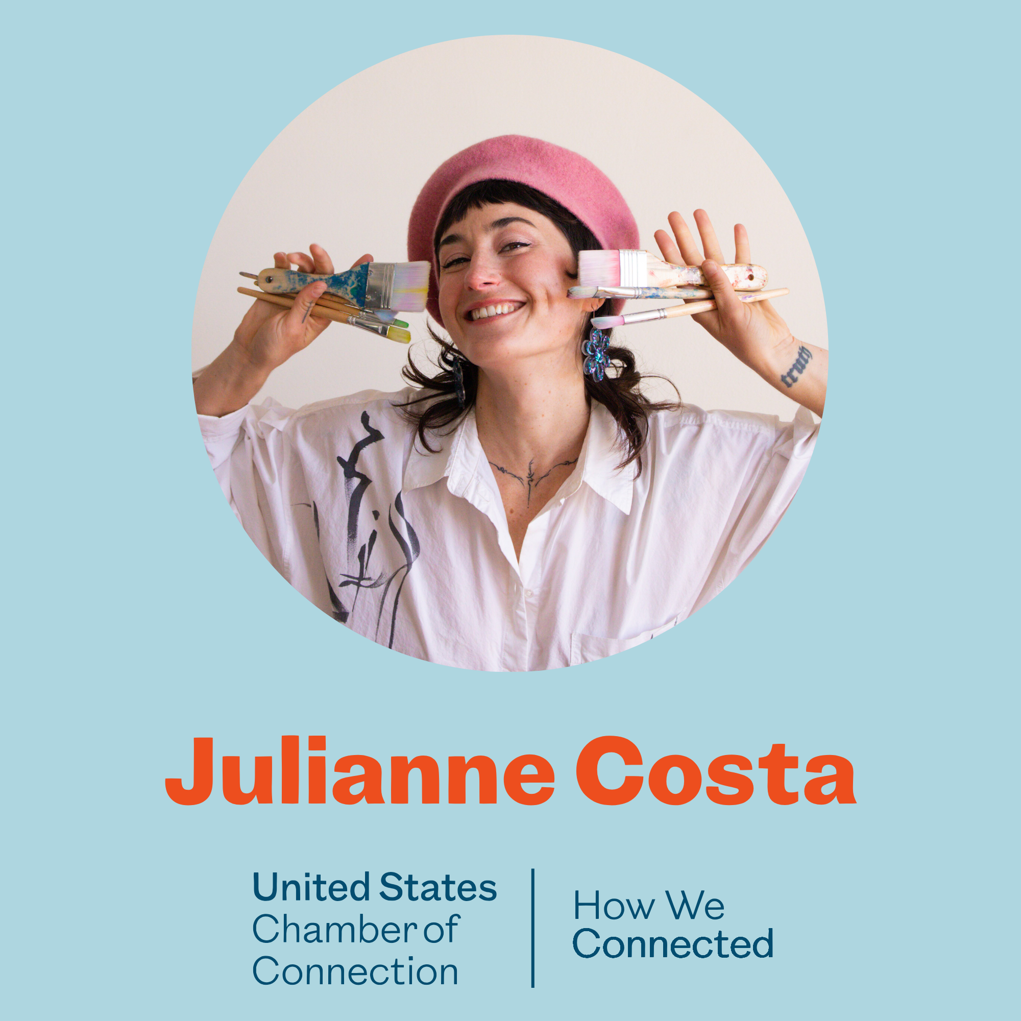 A woman wearing a pink beret and earrings with fish-shaped earrings is smiling and holding multiple paintbrushes around her face. The background has a light blue color with orange and blue text that reads 'Julianne Costa' and mentions an organization related to the United States Chamber of Commerce.