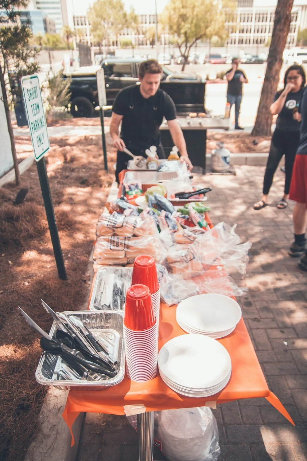 A potluck table of shared food at a neighborhood block party