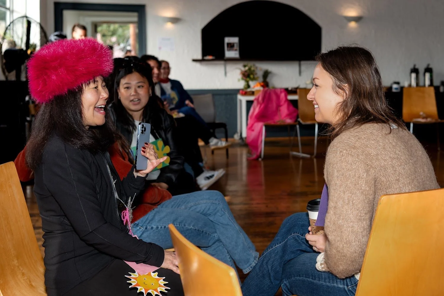 Two new friends laughing together at a Seattle Chamber of Connection gathering