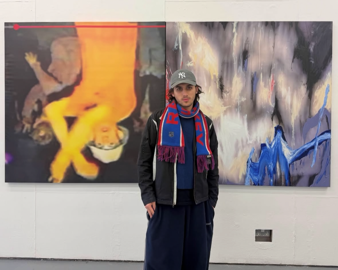 image of joe sookias standing in front of two large scale artworks
