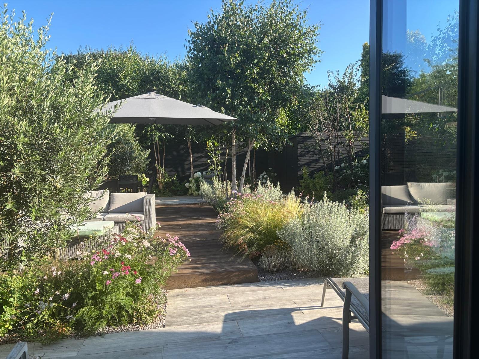 Raised seating area, immersed in fragrant and colourful planting