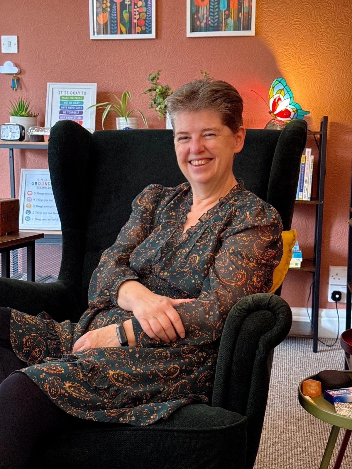 A photo of me, sitting in my chair in my counselling room.