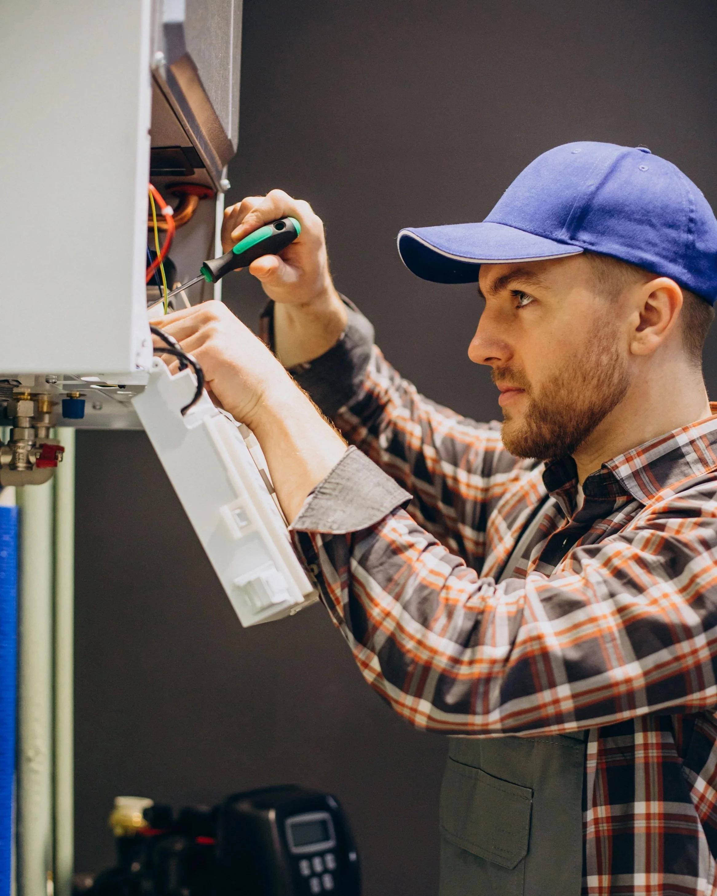 Boiler repair and servicing in Ealing with certified engineer inspecting heating system.