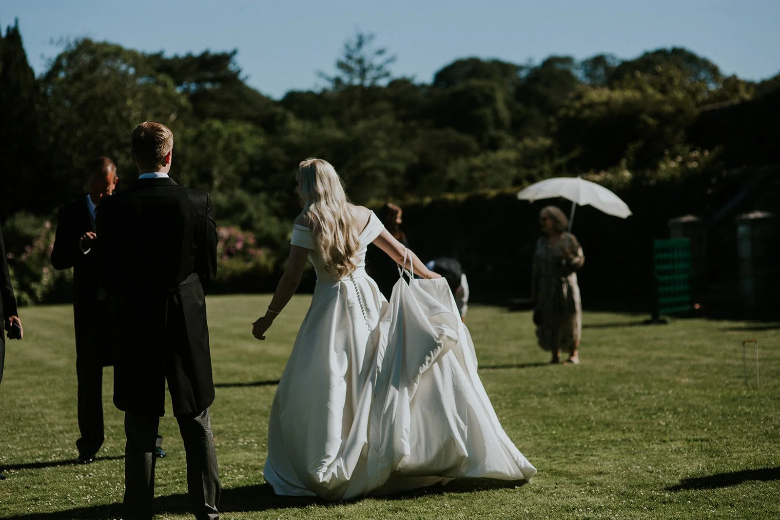 Bride and groom with guests on the terrace. Photographed by Lucy Lloyd Jones.
