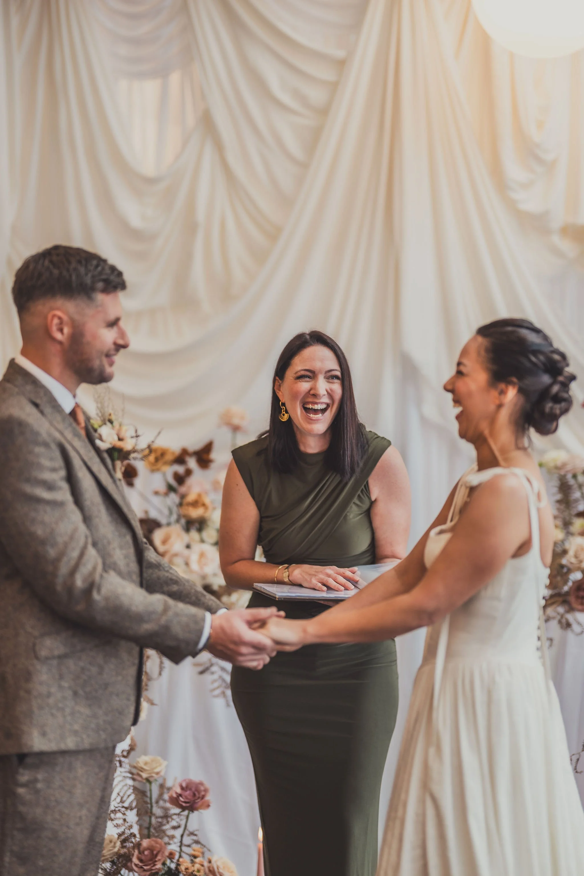 Celebrations with Natalie stood with a couple, all smiling.