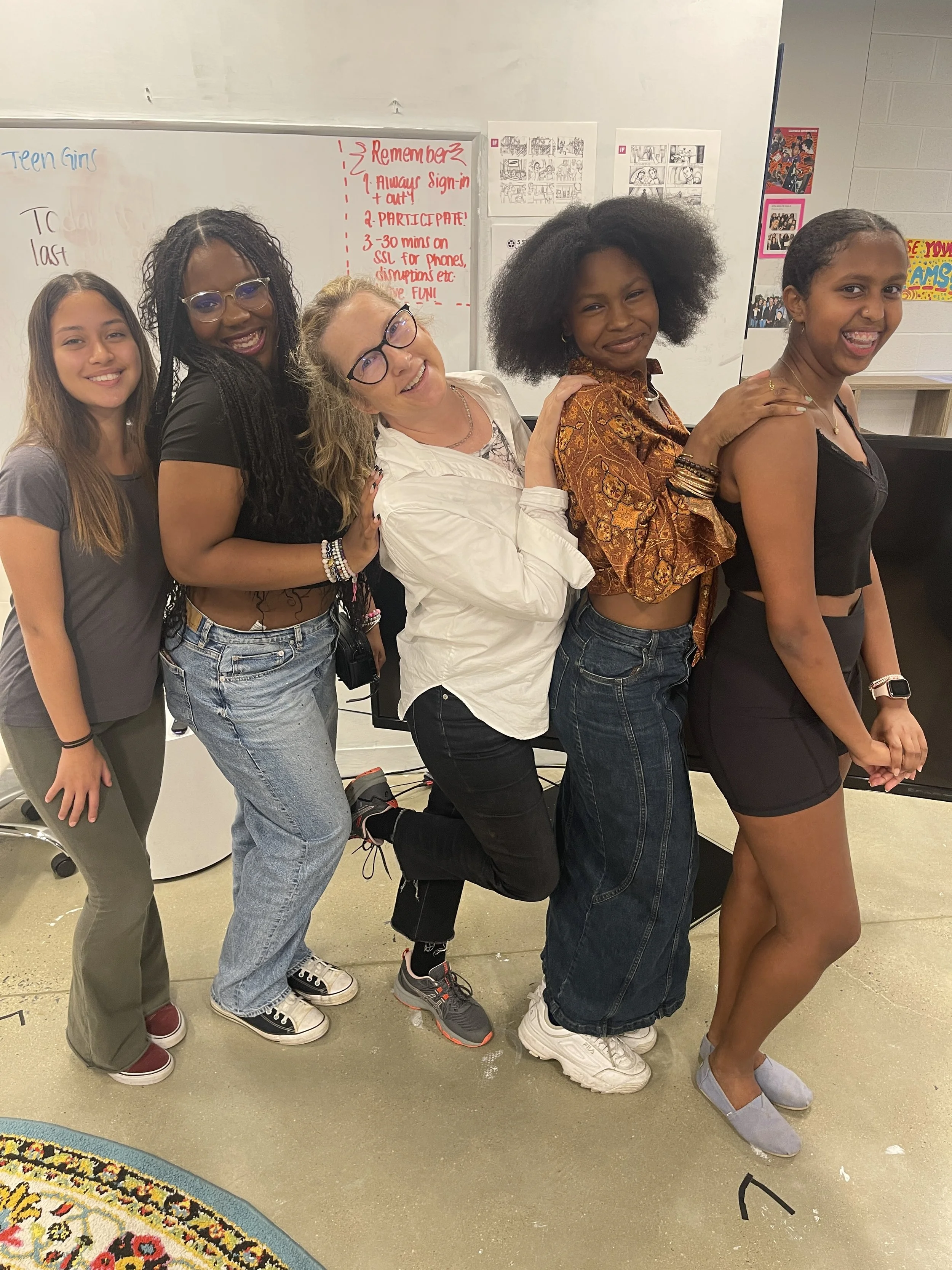 Five people in a strange conga line, facing right.