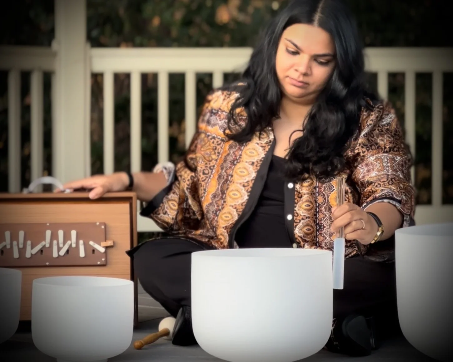 Sudha McFadden playing crystal singing bowls at a sound bath in South Carolina